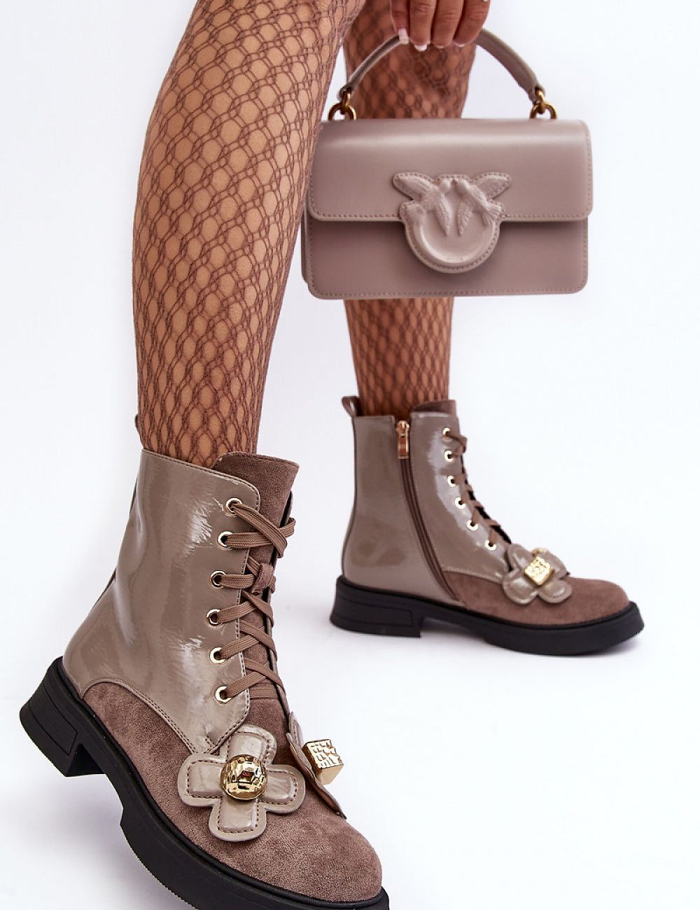 Woman wearing Florynne Floral-Laced Winter Boots with patterned tights and holding a matching taupe handbag.