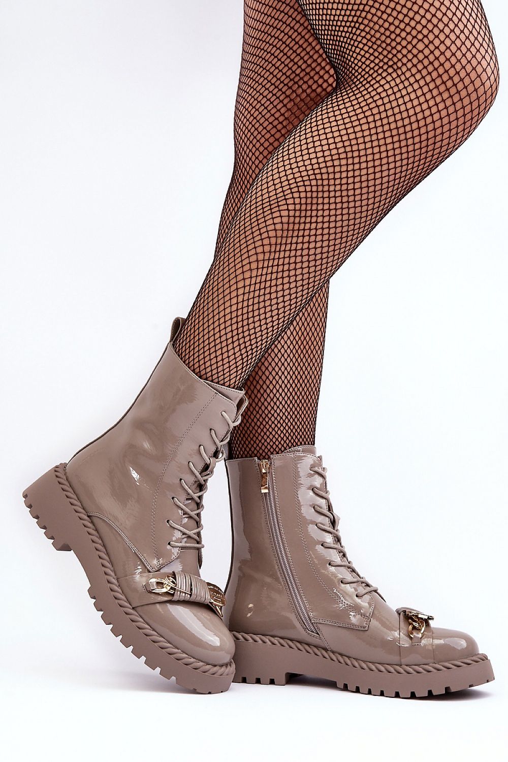 Jevira Gold-Trim Platform Boots in eco leather with gold accents, side zipper, and durable sole, styled with fishnet stockings.