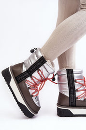 Fashionable silver snow boots with red laces and thick sole, perfect for winter style and comfort.
