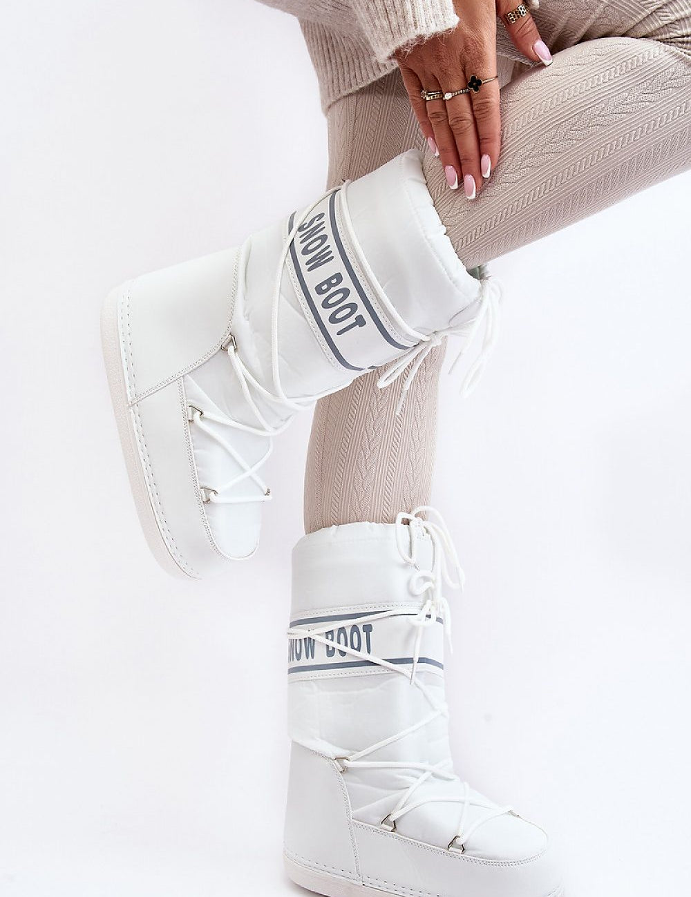 Stylish white Astrella High Platform Snow Boots with eco leather accents, bold lettering, and dual lacing, perfect for winter warmth and grip.