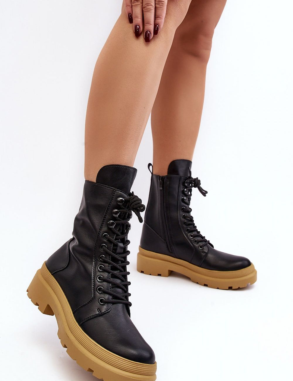 Black eco leather ankle boots with a thick tan platform and front lacing, perfect for seasonal transitions, offering style and comfort.