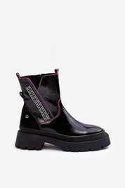 Stylish black ankle boot with pink accents and chunky sole on white background.