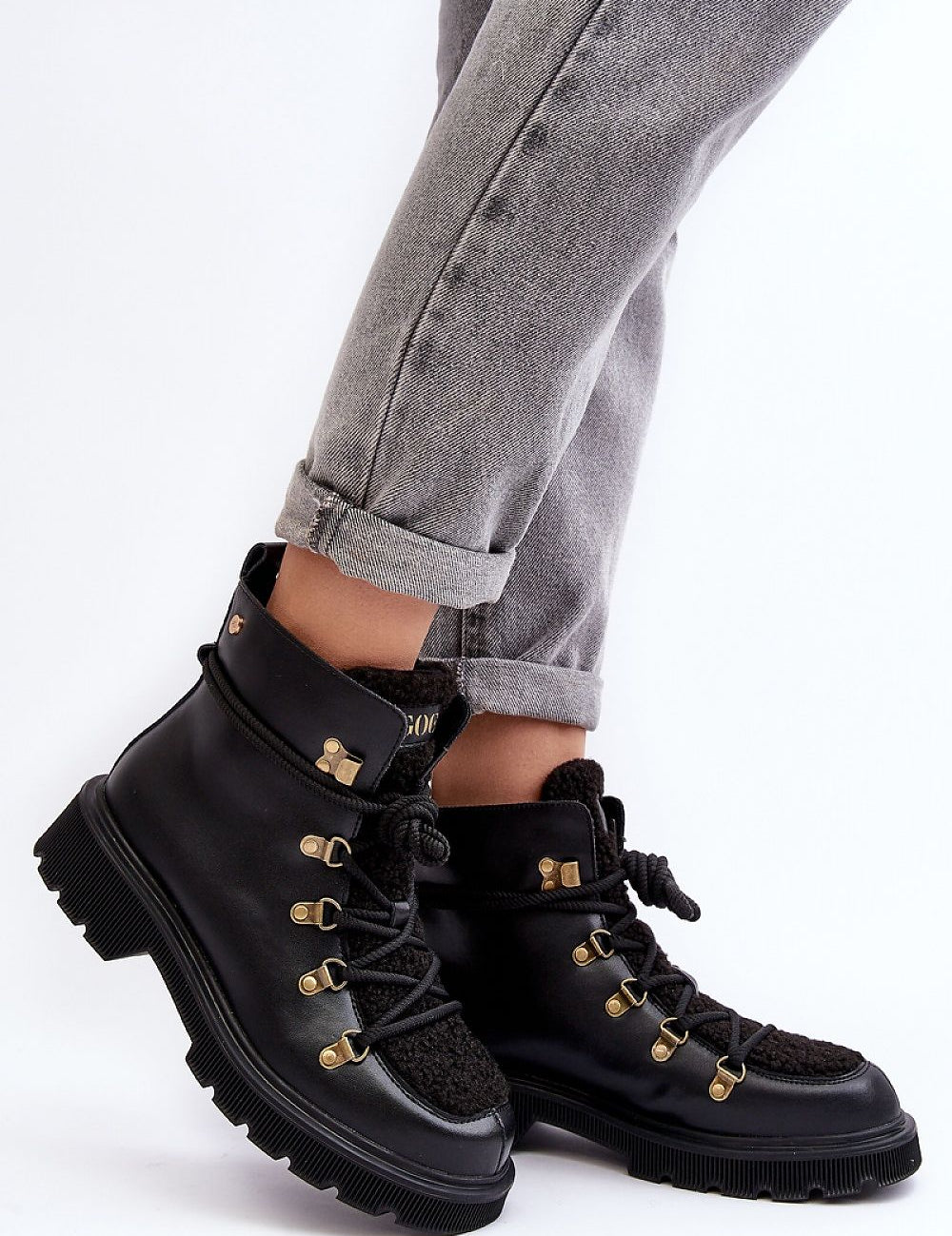 Larkwood Leather Winter Trapper Boots with durable leather exterior and lace-up design, worn with rolled-up jeans for a stylish look.