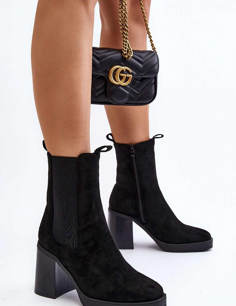 Woman wearing Ardelia Suede Platform Heel Boots with black handbag, showcasing stylish eco-suede design and chunky block heels.