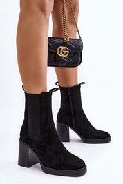 Woman wearing Ardelia Suede Platform Heel Boots with black handbag, showcasing stylish eco-suede design and chunky block heels.