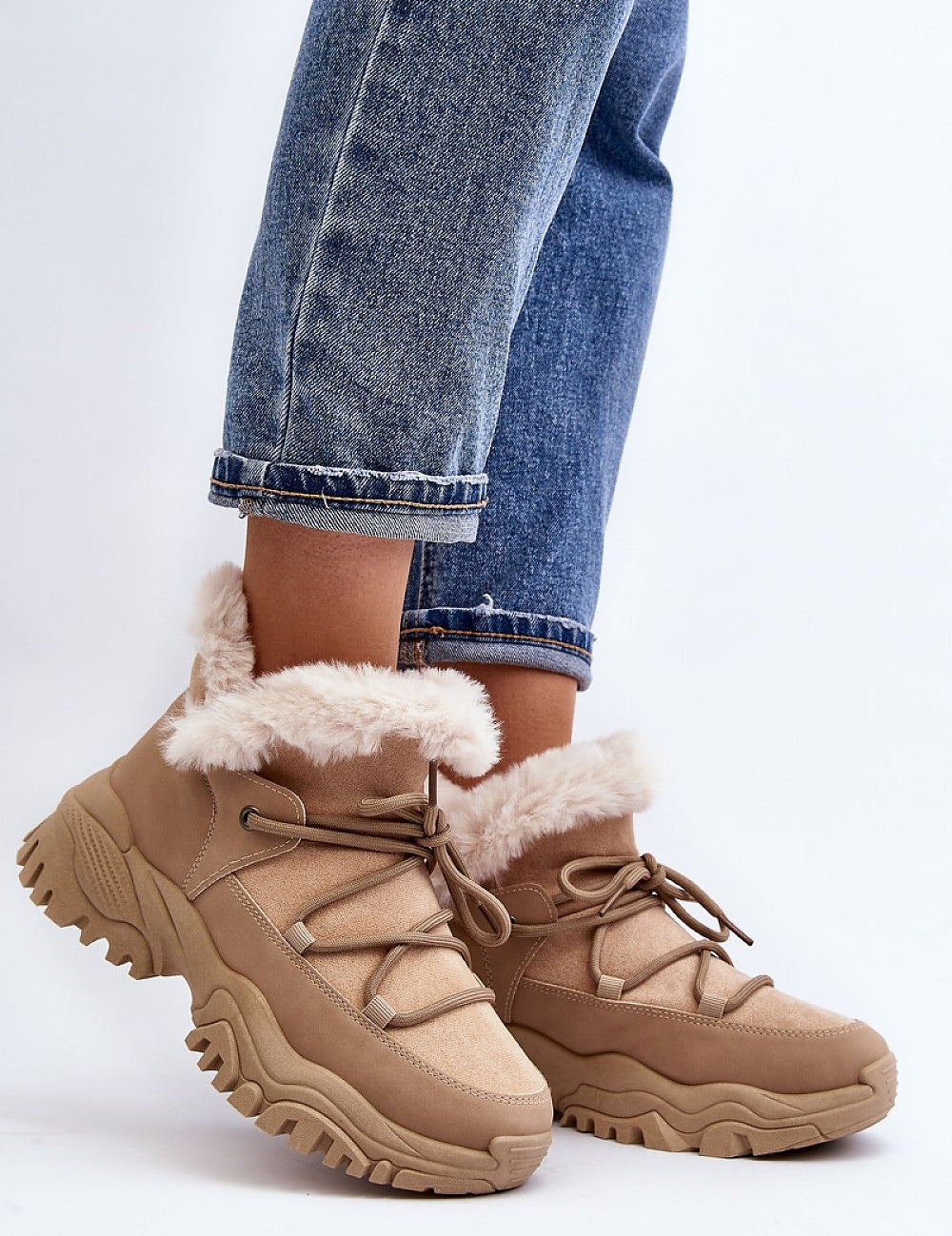 Person wearing Velora faux fur-lined winter sneakers with eco leather and sporty lacing, showcasing comfort and style.