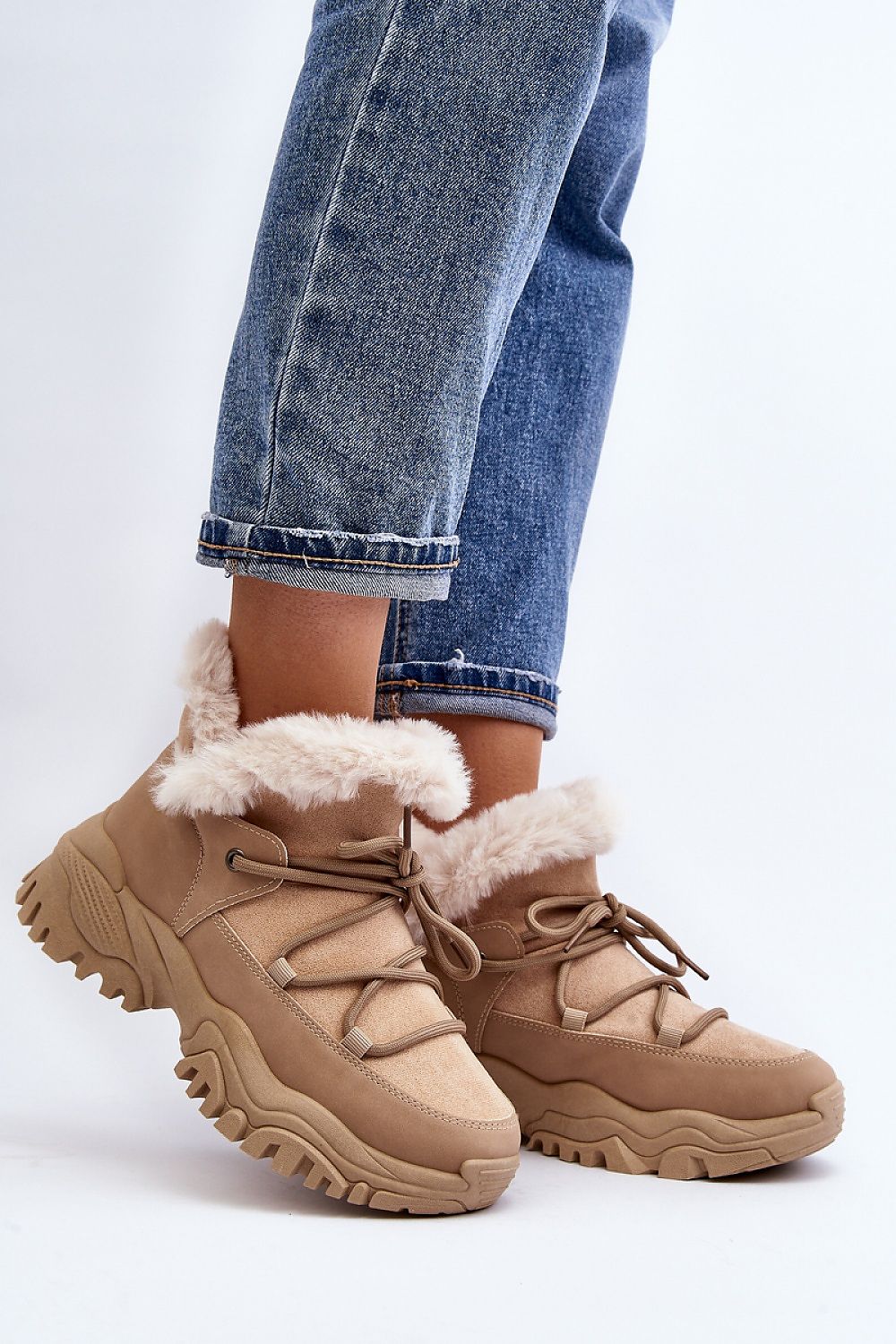 Person wearing Velora faux fur-lined winter sneakers with eco leather and sporty lacing, showcasing comfort and style.