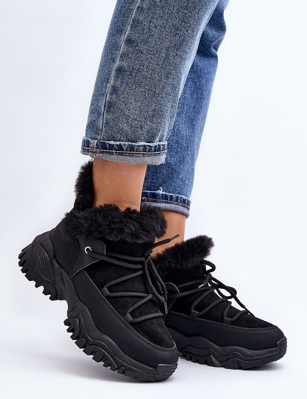 Velora Faux Fur-Lined Winter Sneakers on person wearing jeans; black eco leather with faux fur and sporty lacing for comfort and style.
