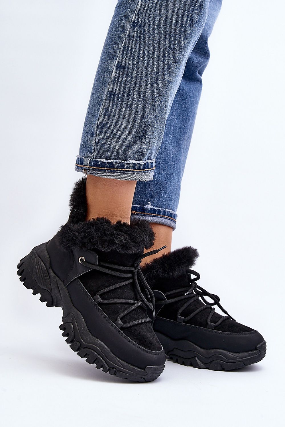 Velora Faux Fur-Lined Winter Sneakers on person wearing jeans; black eco leather with faux fur and sporty lacing for comfort and style.