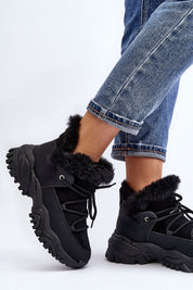 Velora faux fur-lined winter sneakers in black, trapper-style, eco leather, with lacing and platform heel, paired with denim jeans.