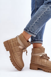 Woman wearing Velda Quilted Slip-On Winter Boots in eco leather with jeans, showcasing ankle-high design and quilted upper.