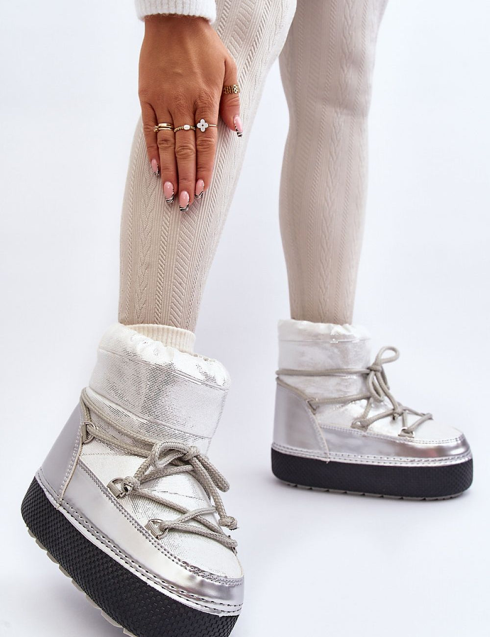 Woman wearing Yllora Platform Snow Boots in silver with thick sole and front laces, showcasing cozy winter footwear.