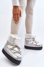 Woman wearing Yllora Platform Snow Boots in silver with thick sole and front laces, showcasing cozy winter footwear.