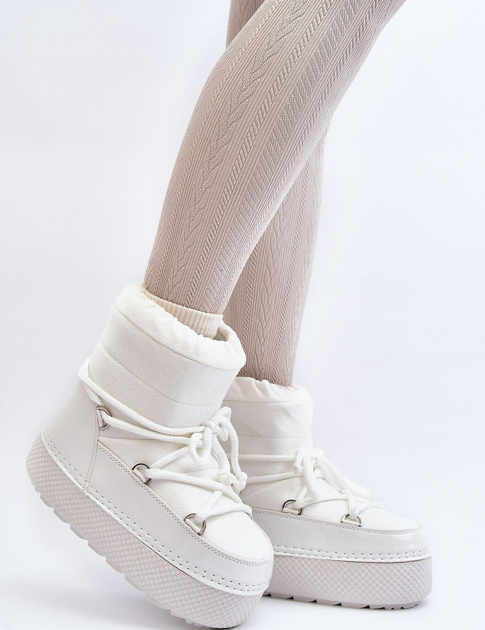 Woman wearing Yllora Platform Snow Boots in white with thick soles and front lacing, perfect for winter warmth and comfort.