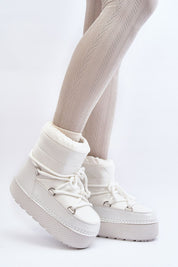 Woman wearing Yllora Platform Snow Boots in white with thick soles and front lacing, perfect for winter warmth and comfort.