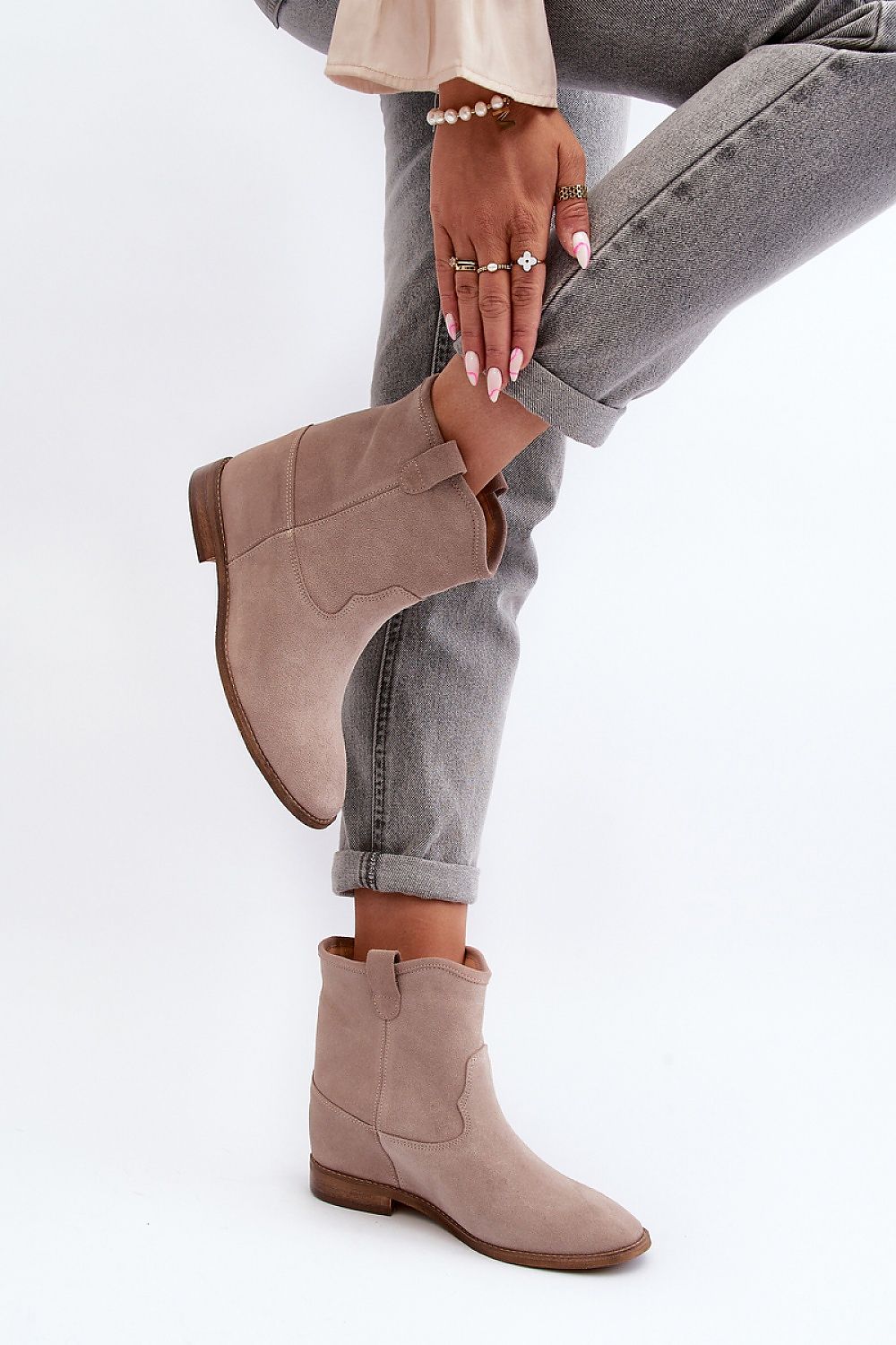 Meredia suede slip-on flat boots with concealed wedge, worn with jeans. Casual and chic footwear for everyday comfort and style.