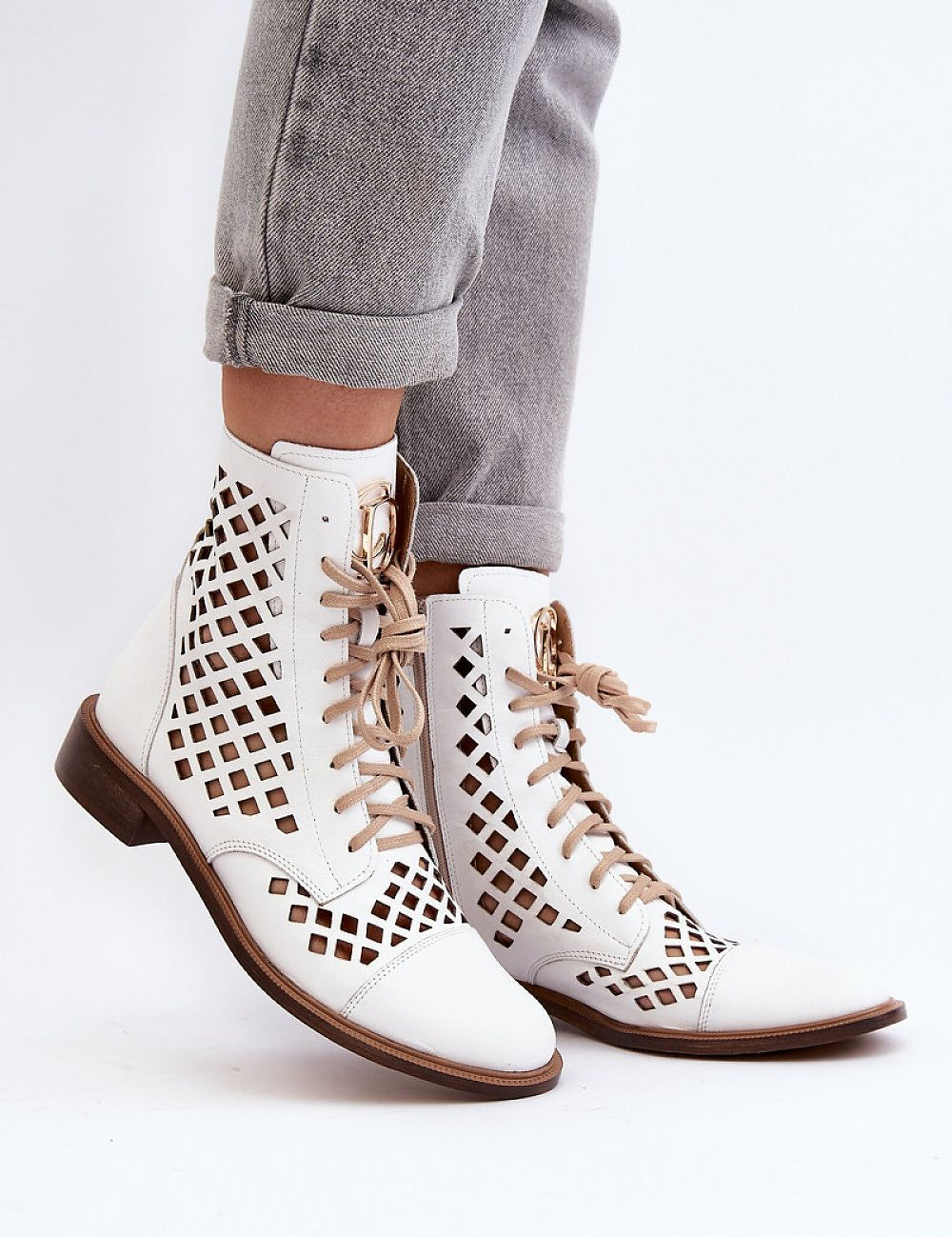 Solvitta perforated leather boots with lace-up front, side zipper, and flat sole, crafted for elegance and comfort.