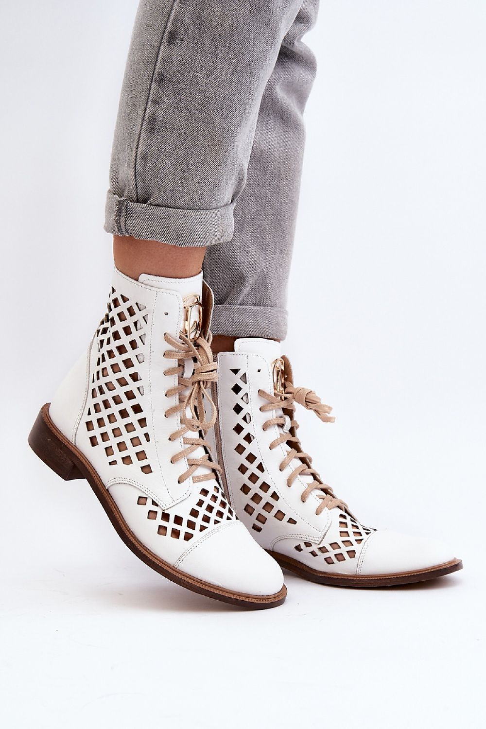 Solvitta perforated leather boots with lace-up front, side zipper, and flat sole, crafted for elegance and comfort.