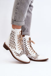 Solvitta perforated leather boots with lace-up front, side zipper, and flat sole, crafted for elegance and comfort.