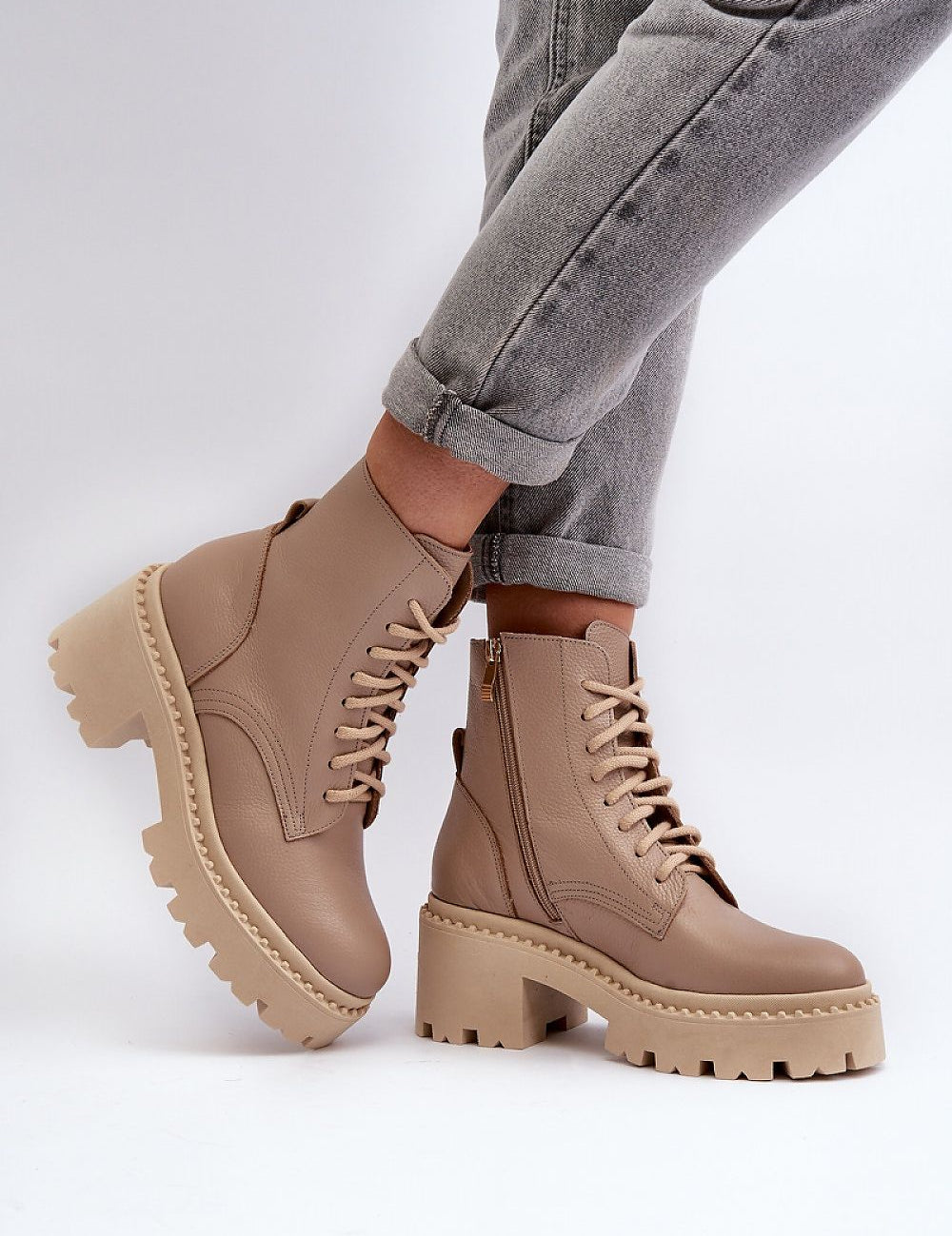 Ravnezza Chunky Leather Lace-Up Boots with block heel and thick sole in brown, worn with rolled-up jeans.
