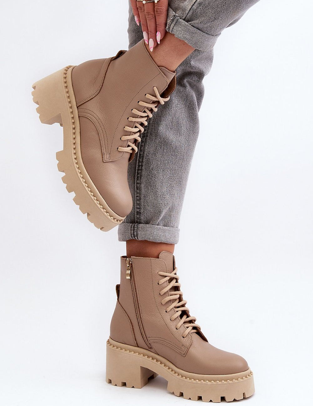 Ravnezza chunky leather lace-up boots with thick sole and block heel, shown in ankle view on model wearing jeans.