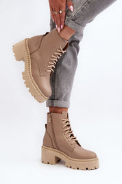 Ravnezza chunky leather lace-up boots with thick sole and block heel, shown in ankle view on model wearing jeans.