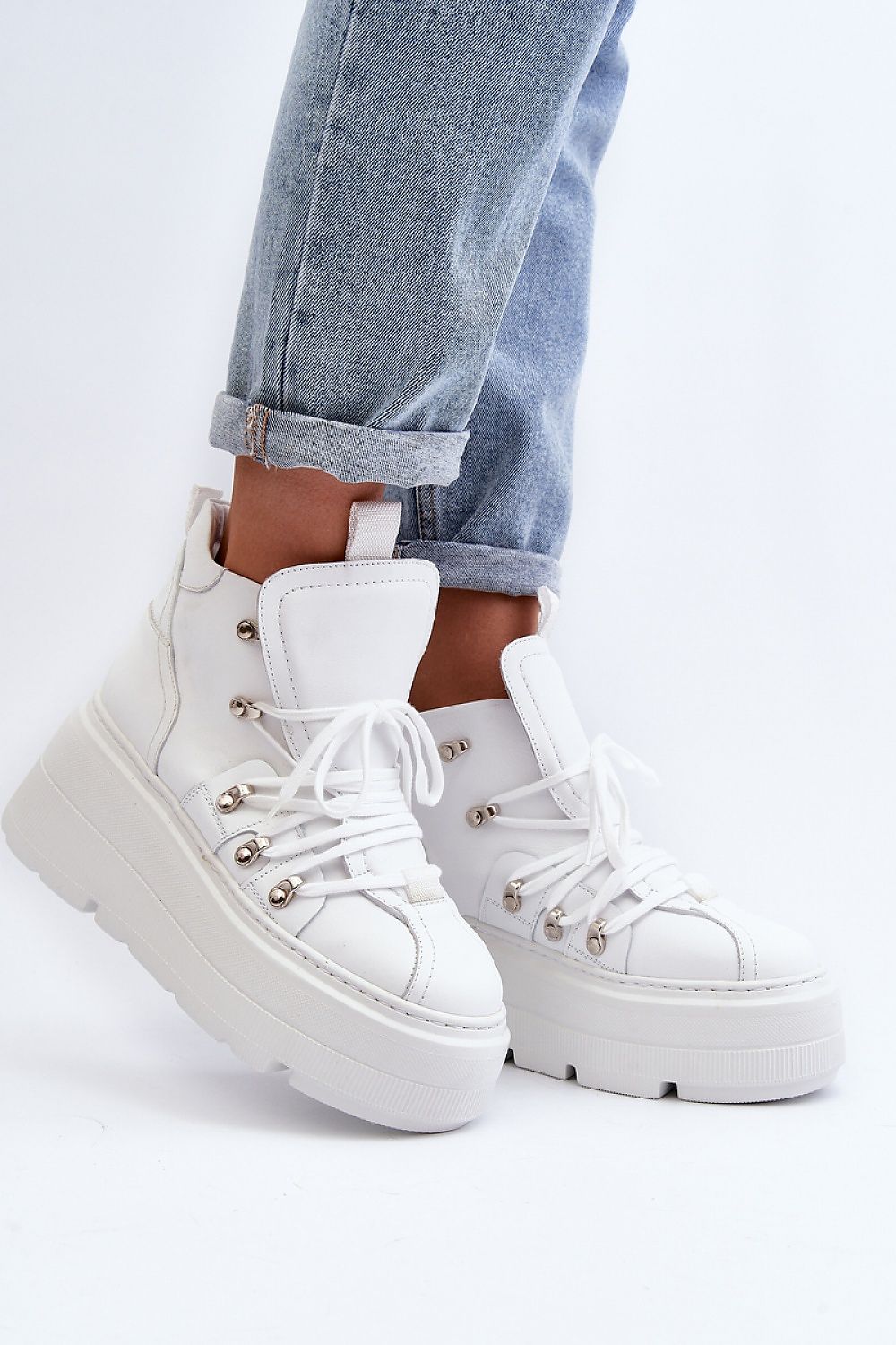 White Ermelle Sculpted Platform Sneakers with laces, genuine leather, high upper, and bold platform, paired with light blue jeans.