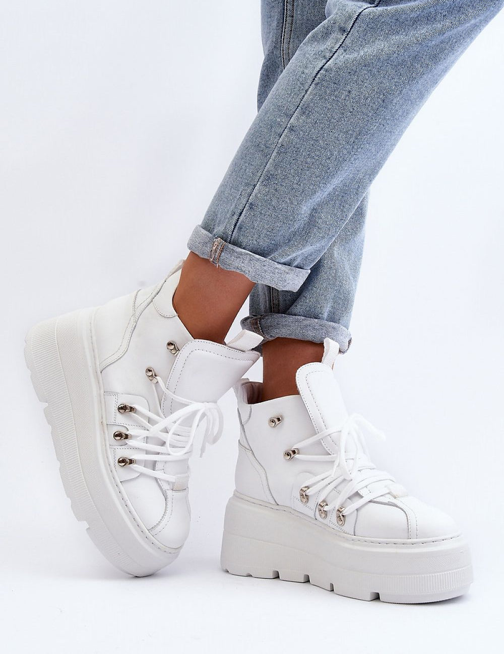 Ermelle Sculpted Platform Sneakers in white leather with chunky sole, worn with rolled-up jeans for a trendy, sporty look.
