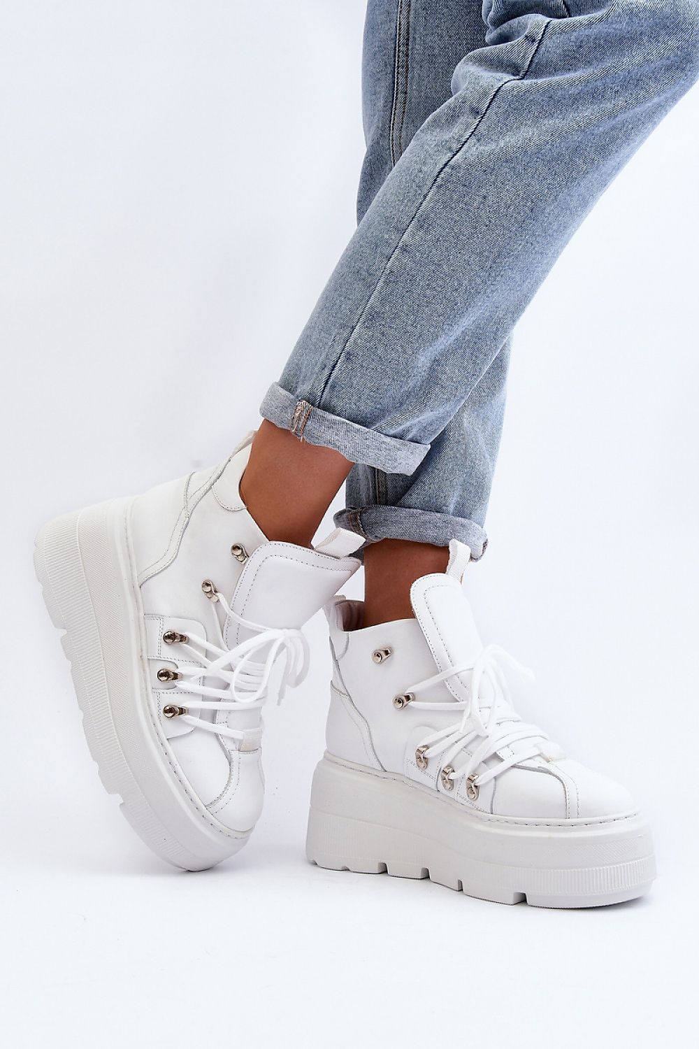 Ermelle Sculpted Platform Sneakers in white leather with chunky sole, worn with rolled-up jeans for a trendy, sporty look.