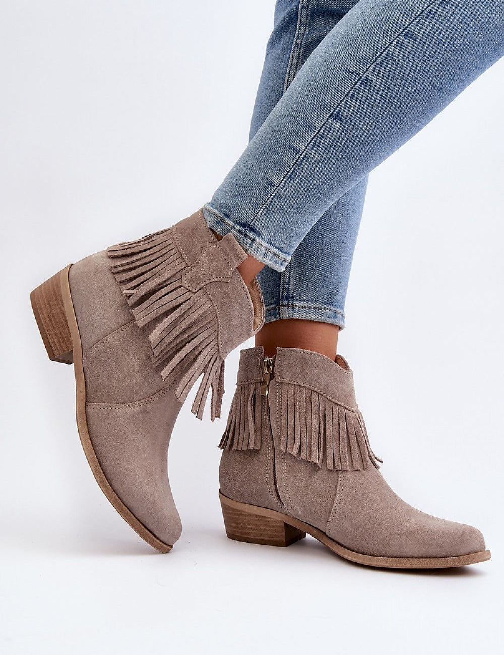Tassava suede boots with tassel accent and side zipper, elegant ankle-length design, worn with jeans, genuine suede leather.