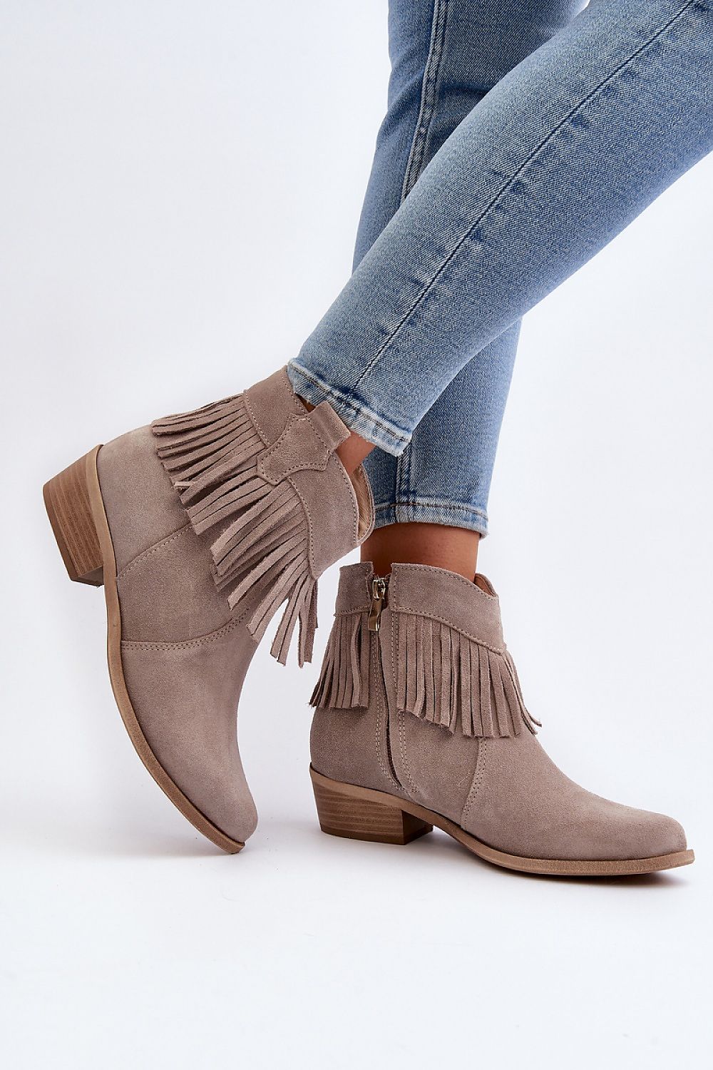Tassava suede boots with tassel accent and side zipper, elegant ankle-length design, worn with jeans, genuine suede leather.