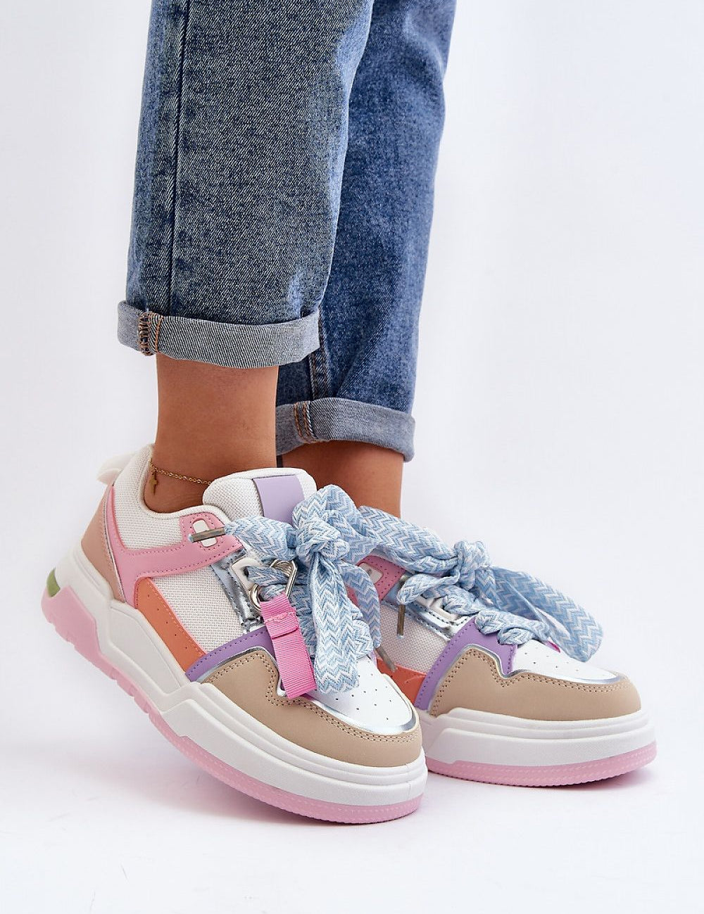 Stylish Ermena Lace-Up Platform Sneakers with pastel colors, high ankle cut, and thick sole, paired with rolled denim jeans.