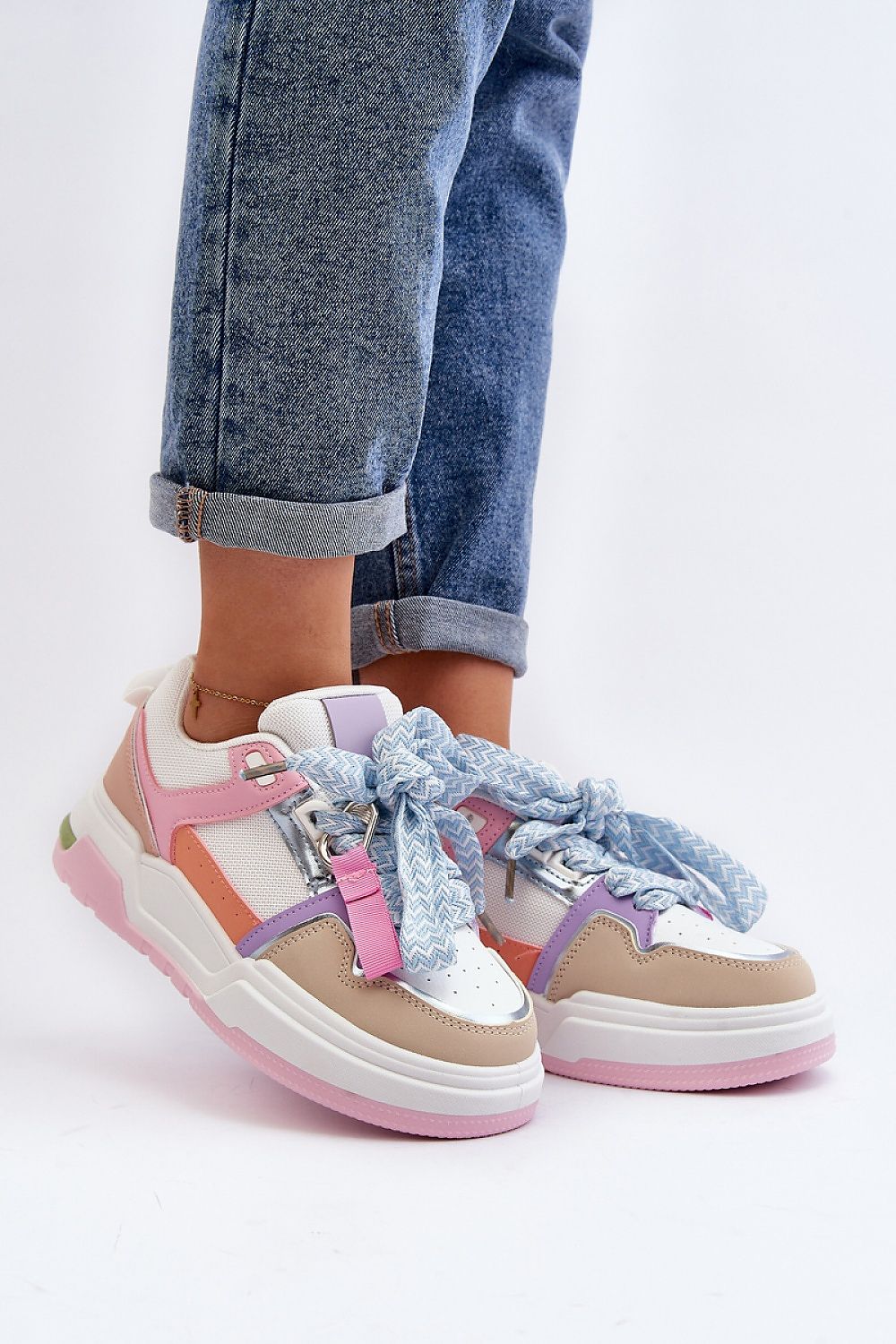 Stylish Ermena Lace-Up Platform Sneakers with pastel colors, high ankle cut, and thick sole, paired with rolled denim jeans.
