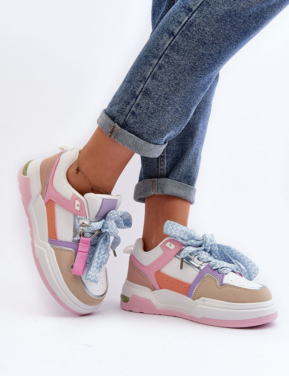 Person wearing colorful lace-up platform sneakers with rolled-up jeans, showcasing modern urban style and eco-friendly materials.