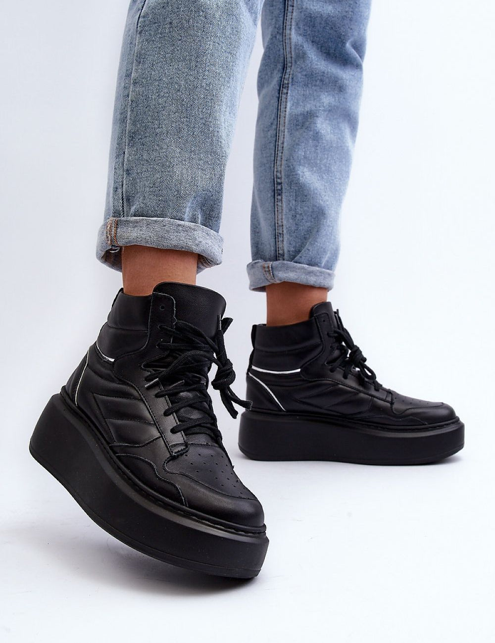 Valonne Leather Platform Trainers with 7 cm heel, black genuine leather, lace-up design, worn with cuffed jeans.