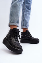 Valonne Leather Platform Trainers with 7 cm heel, black genuine leather, lace-up design, worn with cuffed jeans.
