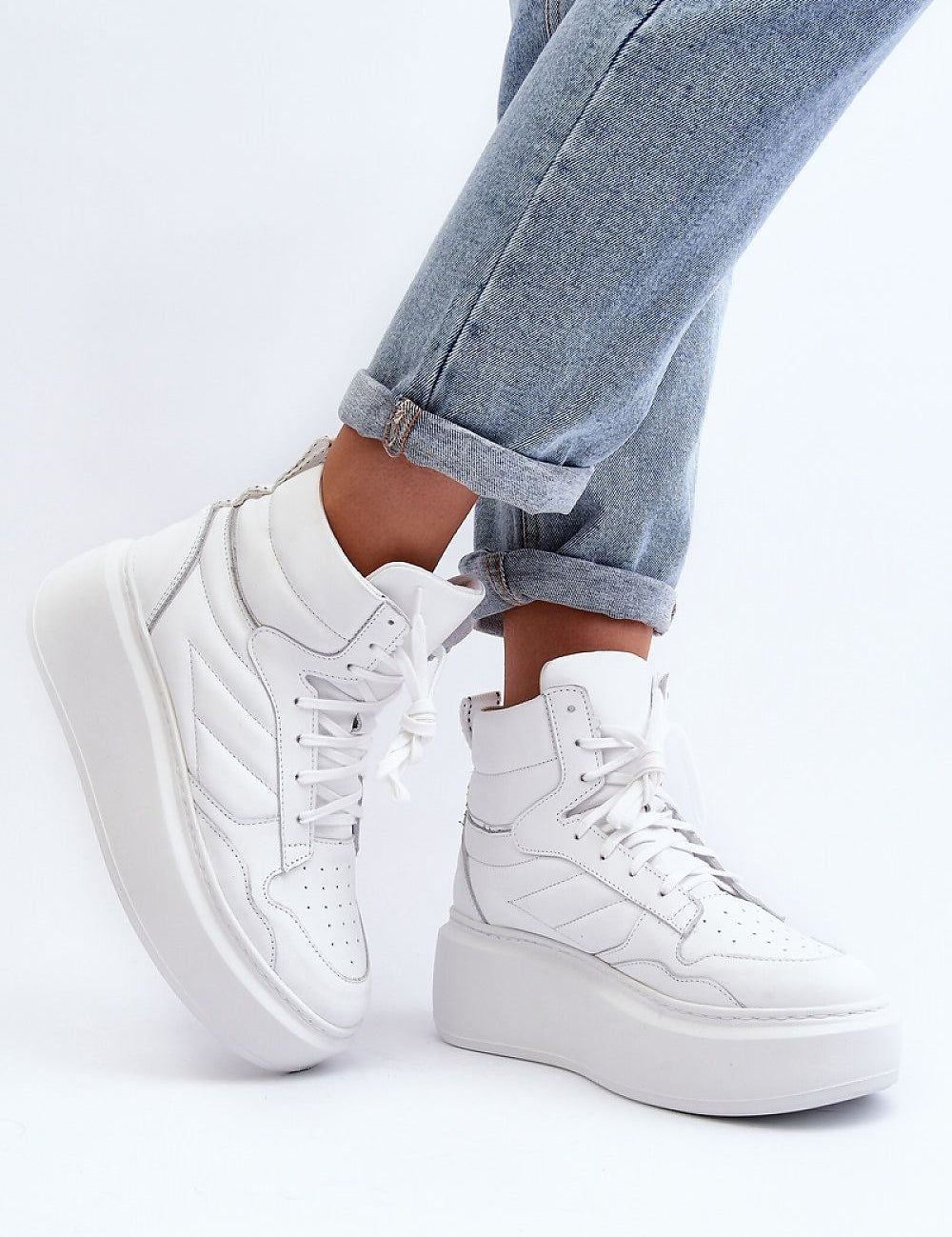 White Valonne Leather Platform Trainers with 7 cm heel and thick sole shown with denim jeans, perfect for spring fashion.