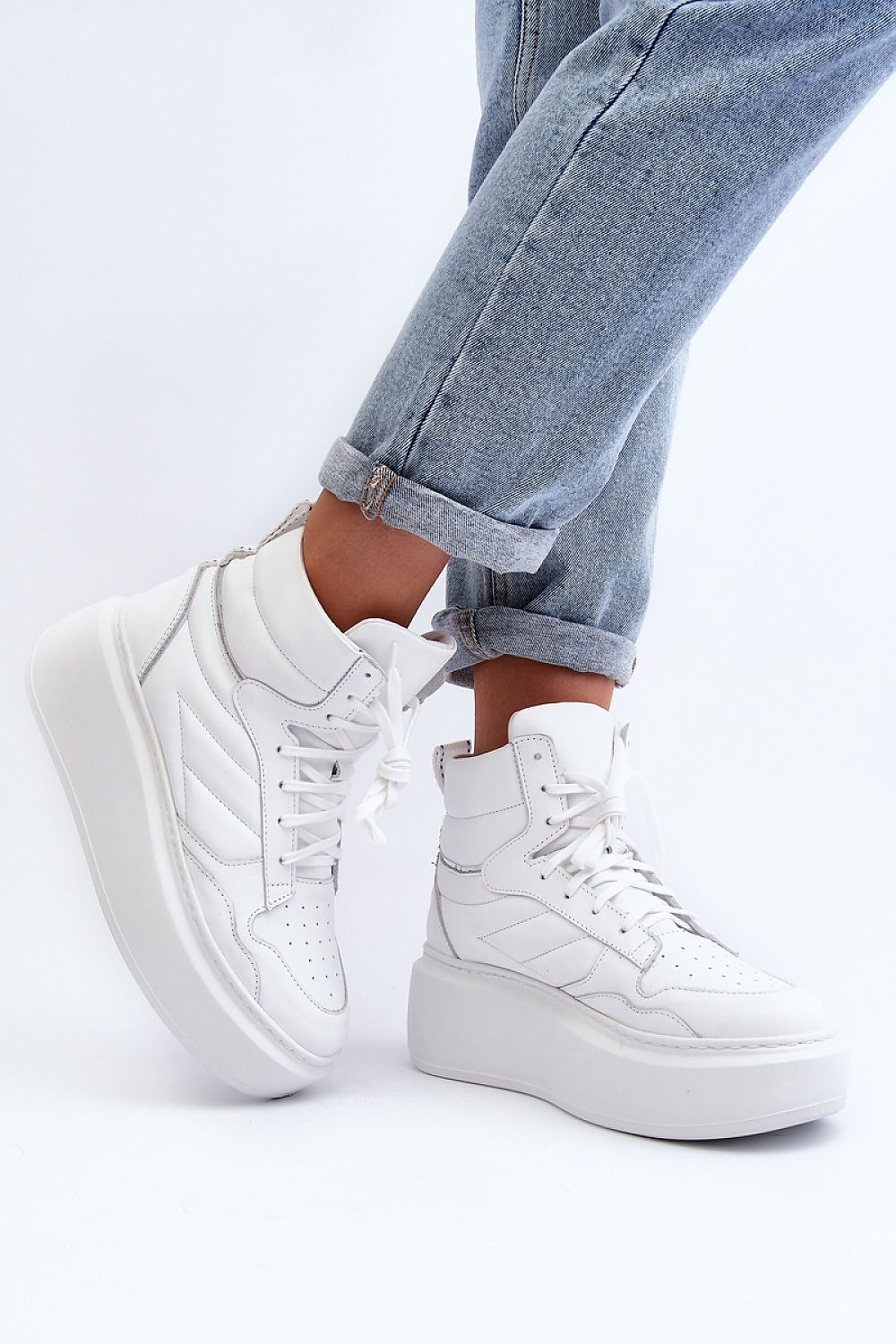White Valonne Leather Platform Trainers with 7 cm heel and thick sole shown with denim jeans, perfect for spring fashion.