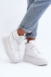 White Valonne Leather Platform Trainers with 7 cm heel and thick sole shown with denim jeans, perfect for spring fashion.