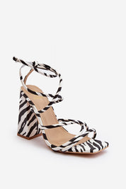 Eliore High Heel Buckled Sandals in zebra print with open design and adjustable ankle strap, featuring a sculptural wide post heel.