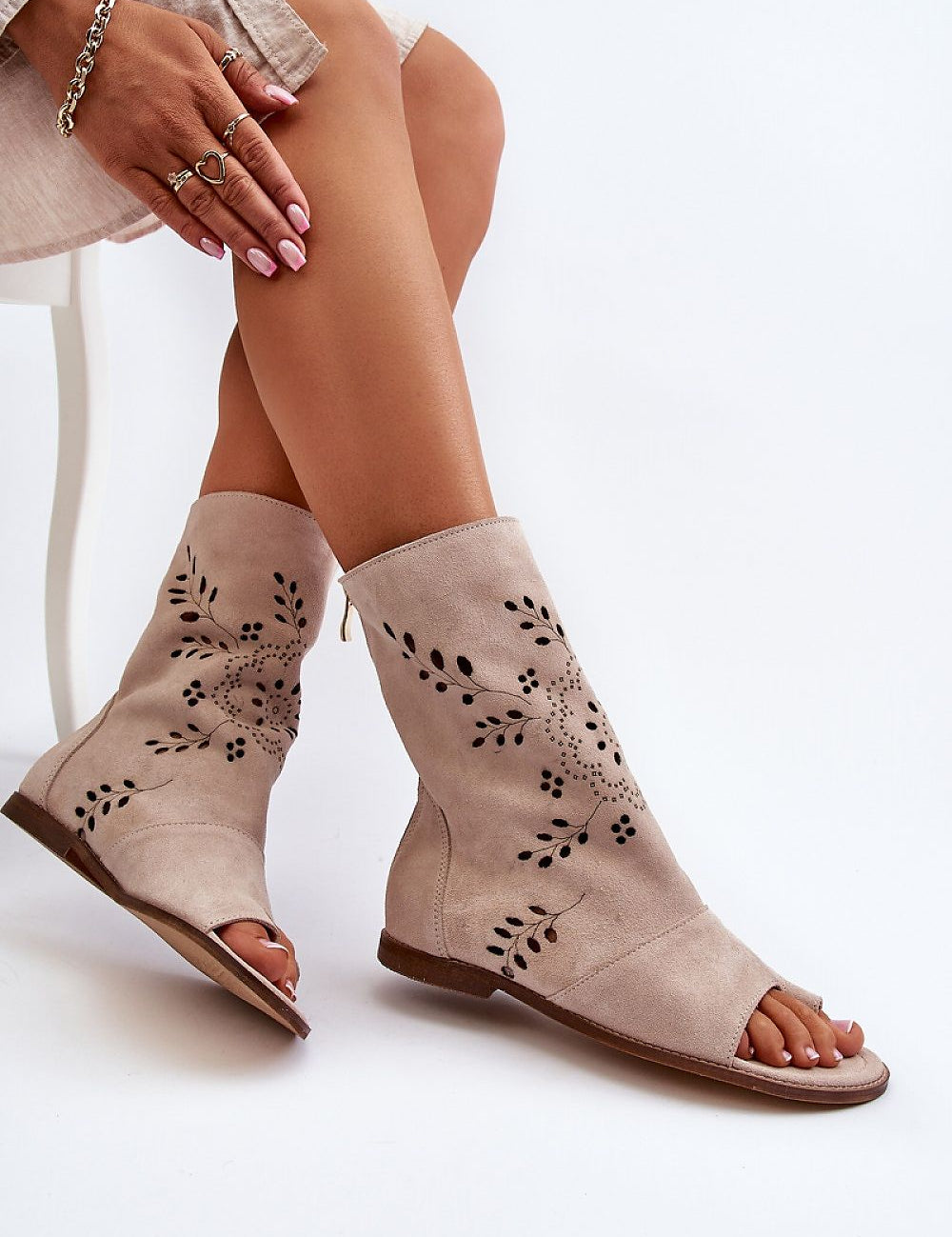 Stylish Avelynna suede openwork zip sandals in natural color, featuring intricate designs and flat heel for comfort and elegance.