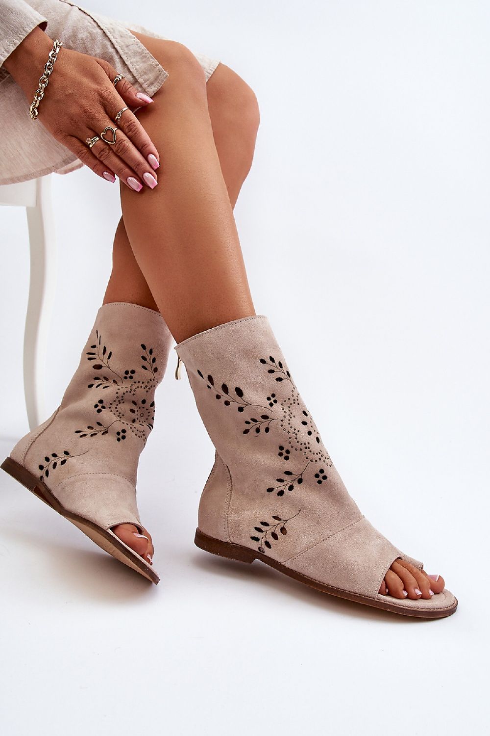 Stylish Avelynna suede openwork zip sandals in natural color, featuring intricate designs and flat heel for comfort and elegance.