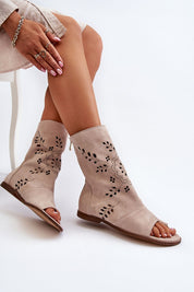 Stylish Avelynna suede openwork zip sandals in natural color, featuring intricate designs and flat heel for comfort and elegance.