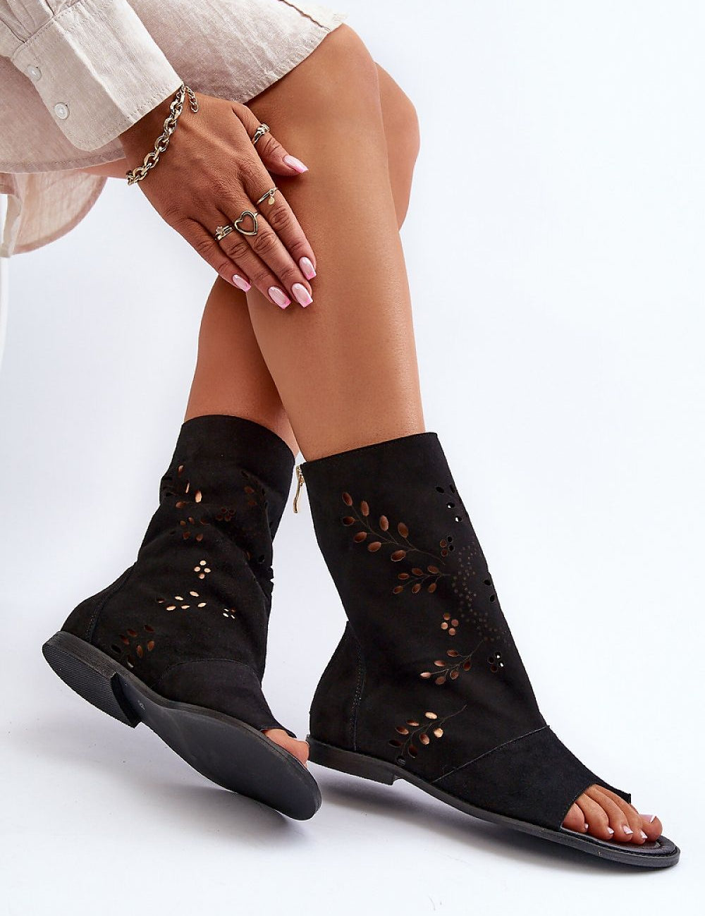 Avelynna Suede Openwork Zip Sandals with intricate detailing, black flat heel, and high zippered upper, worn by model.