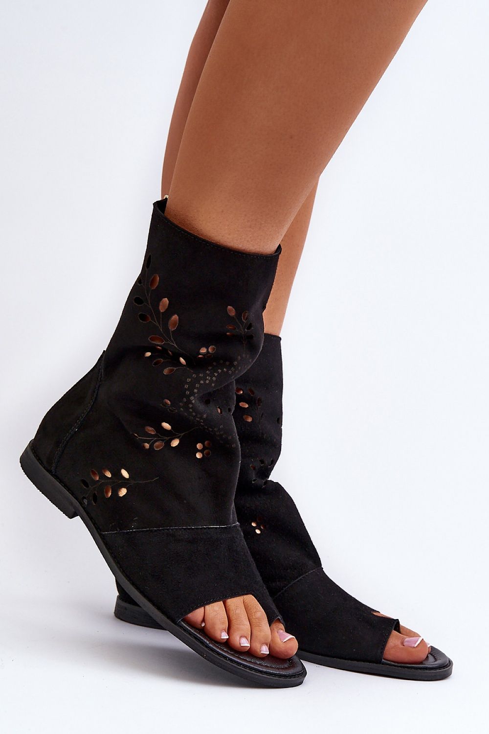 Black suede openwork zip sandals with flat heel and soft leather insole, offering elegant style and comfort.