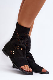 Black suede openwork zip sandals with flat heel and soft leather insole, offering elegant style and comfort.