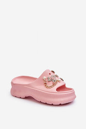 Pink Orminya foam platform slides with decorative accents and thick sole, offering comfort and height for warm-weather styling.