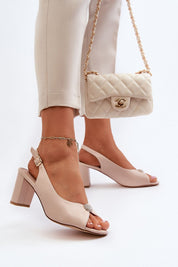 Woman wearing Nivaria Ornamented Heel Strap Sandals with eco leather and shimmer accent; elegant style for summer events.