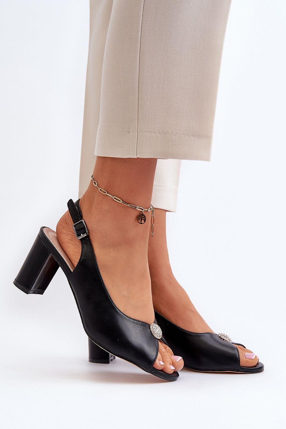 Black Nivaria Ornamented Heel Strap Sandals with decorative accent and shimmer, featuring a structured heel and adjustable buckle strap.