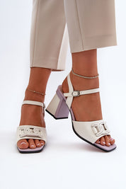 Woman wearing Aurelenna Post Heel Sandals with accent, featuring eco leather, high post heel, ankle strap, and decorative front element.